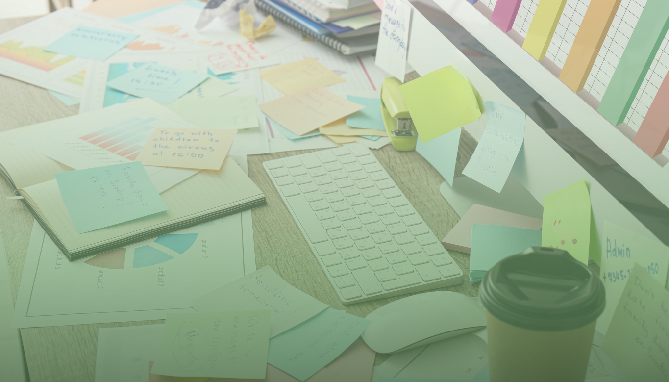 business owner desk piled up with things to do including accounting and tax tasks