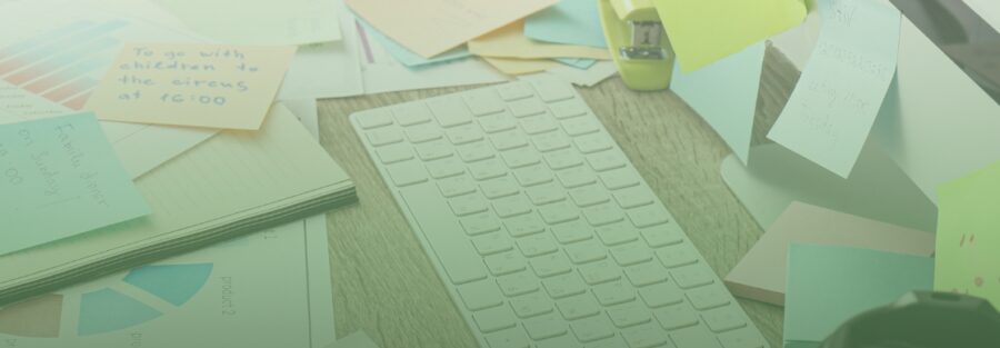 desk piled up with things to do including, post-its, graphs of accounting and tax tasks